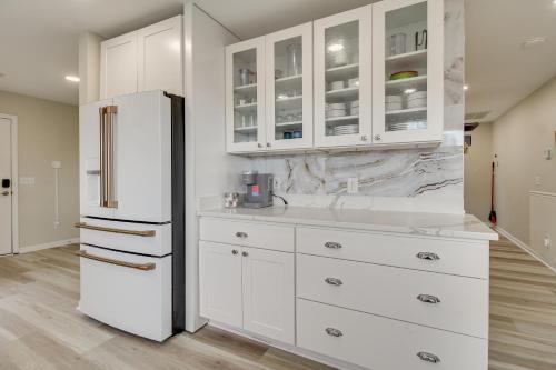 a kitchen with white cabinets and a refrigerator at Riverfront Savannah Retreat with Private Dock! in Savannah