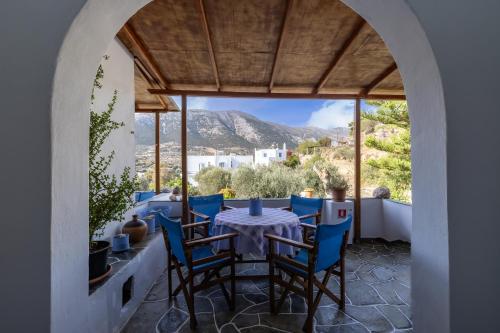 a table and chairs on a balcony with a view at Katerina Studios Mparou in Apollonia