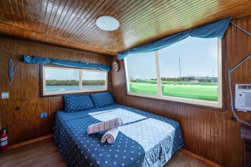 a bedroom in a boat with a bed in it at Beautiful Houseboat in Key West in Key West