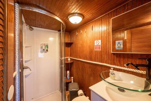 a bathroom with a shower and a sink and a toilet at Beautiful Houseboat in Key West in Key West