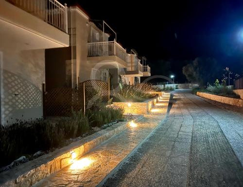 a building with lights on a street at night at 8 Homes in Meganisi