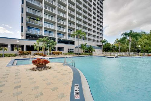 a swimming pool in front of a large building at 1 Mi to Disney World Lakefront Condo in Orlando! in Orlando
