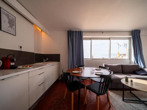 a kitchen and living room with a table and a couch at Appartement 5 couchages Gare St Charles/Joliette in Marseille