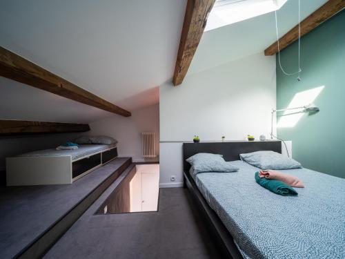 a bedroom with two twin beds and a bed with a person laying on it at Appartement 5 couchages Gare St Charles/Joliette in Marseille