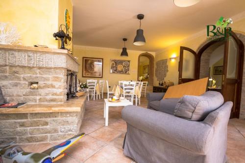 a living room with a couch and a fireplace at B&B dell'Aviatore in San Liberato