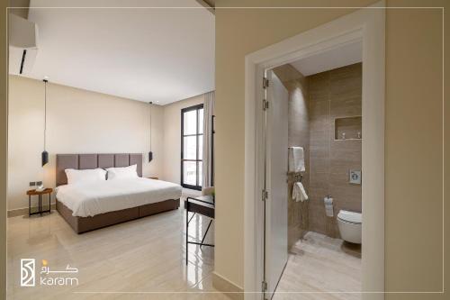 a bedroom with a bed and a bathroom with a shower at جوهرة المغرزات Al Mugharazat jewel in Riyadh