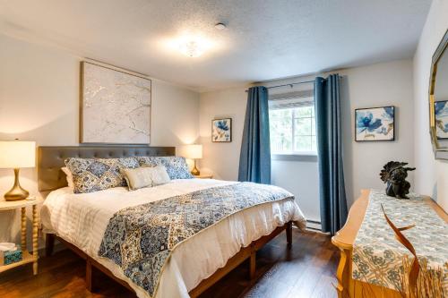 a bedroom with a large bed with blue curtains at Peaceful Renton Retreat with Hot Tub Access! in Renton