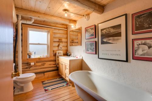 a bathroom with a tub and a toilet and a sink at Philipsburg Log Cabin - Direct Bike Park Access! in Georgetown