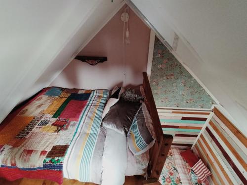 a bedroom with a bed in a attic at Casa Tavaita in Karangahake gorge in Paeroa