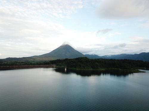 a view of a mountain from a lake at La Fortuna Lodge by Treebu Hotels in Fortuna