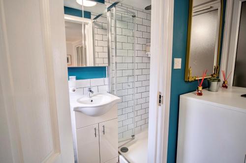 a bathroom with a sink and a shower at Little Garden View in St. Albans