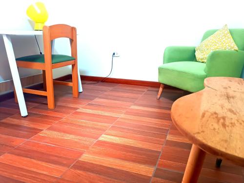 a living room with a green couch and a table at CASONA SANTA MARTA in Arequipa