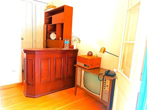 a room with a tv and a wooden cabinet at CASONA SANTA MARTA in Arequipa