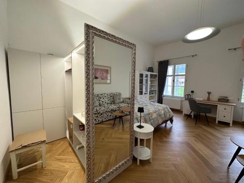 a large mirror in a room with a bedroom at Kaštieľ Ladce 