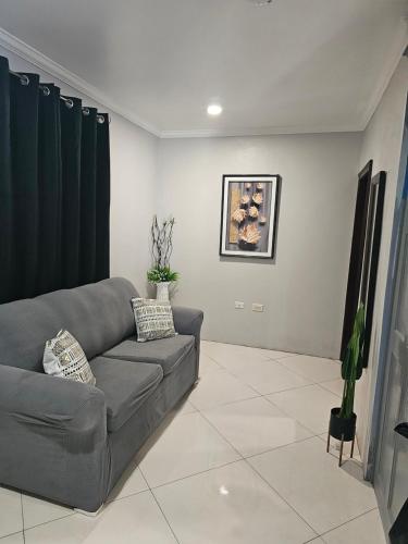 a living room with a gray couch in a room at Secret Hideaway in Ocho Rios