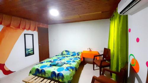 een slaapkamer met een bed en een tafel. bij Nahimara Champeta Hostel in Cartagena