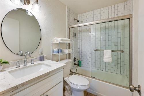 a bathroom with a sink and a toilet and a mirror at Sunny Yuma Vacation Rental with Private Pool! in Yuma