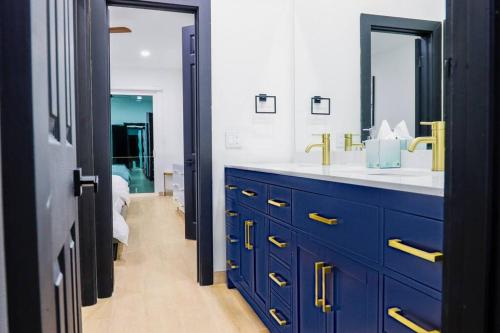 a blue bathroom with a sink and a mirror at Lake Home: Relax and Unwind in Mission Hidden Gem in Mission