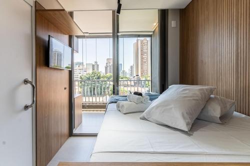 Postel nebo postele na pokoji v ubytování Studios Novíssimos com Piscina no Rooftop e vista para o Allianz Parque