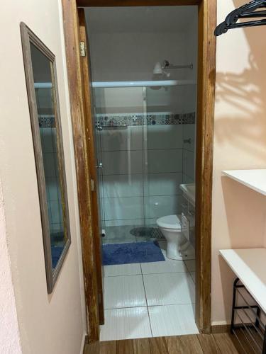 a bathroom with a shower and a toilet at Sweet Room in Mogi Mirim