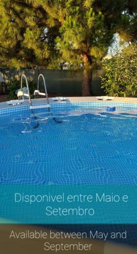 a swimming pool with a sign that readsemetery between may and september at Quinta dos Viegas in Faro