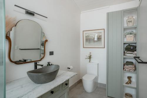 a bathroom with a sink and a mirror at The River Stables 
