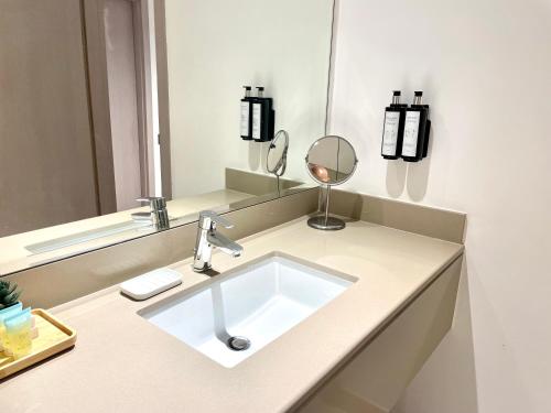 a bathroom with a sink and a mirror at The Hive Retreats in Yas Island in Abu Dhabi