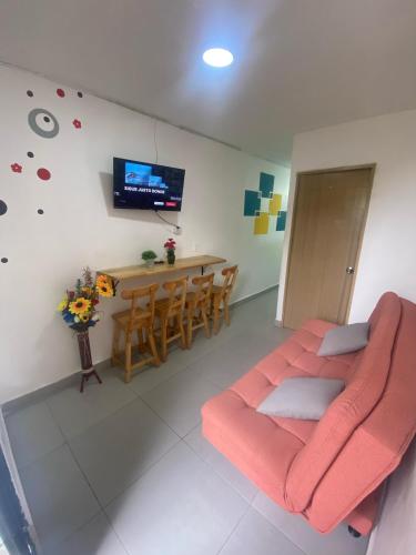 a living room with a couch and a dining room at 22 APARTAMENTO 3 habitaciones CON BALCON EN LAURELES ESTADIO in Medellín