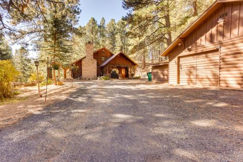 a house with a garage and a barn at Pet-Friendly Bayfield Cabin with Game Room and Hot Tub in Vallecito