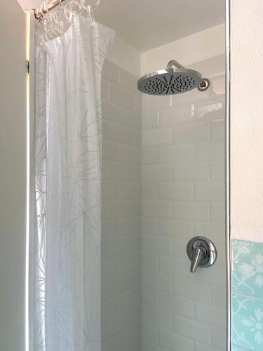 a shower with a white shower curtain in a bathroom at Residence Intur in Marciana Marina