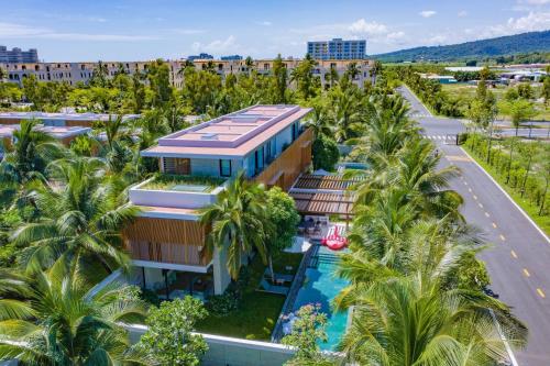 an aerial view of a resort with palm trees at Lucie Villa Phu Quoc - 4 Bedroomss in Phú Quốc