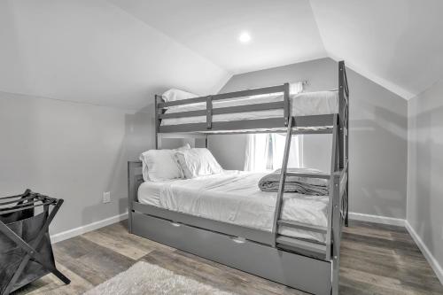 a bedroom with a bunk bed with white sheets at The Mapleridge Retreat in Buffalo