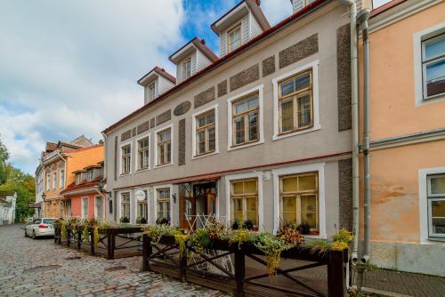 a row of buildings on a street in a city at Romeo Family Uus Apartments in Tallinn
