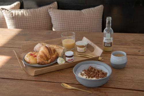 a table with a plate of food and a bottle of milk at LA PENICHE - Bed And Bicycle - Vienne in Vienne