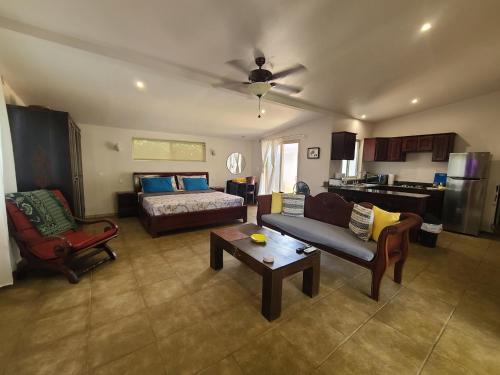 a living room with a couch and a table at Guest House with Shared Pool Access in David