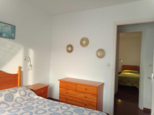 a bedroom with a bed and a dresser and a mirror at Artmony piso centro del pueblo vista frente al mar appartement plein centre en front de mer in Port de la Selva