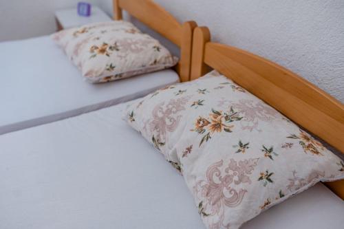 a bed with two pillows on top of it at Vacation home ROT Ohrid in Ohrid