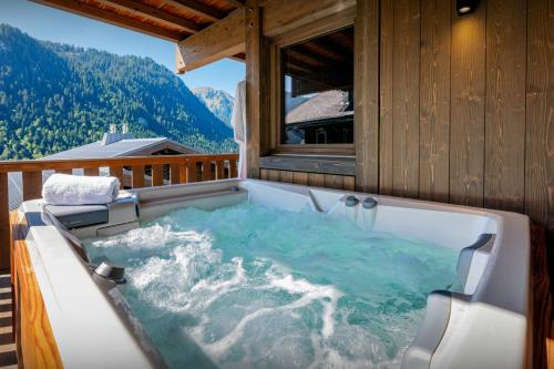 a jacuzzi tub on top of a house at Chalet Amarou - OVO Network in Châtel