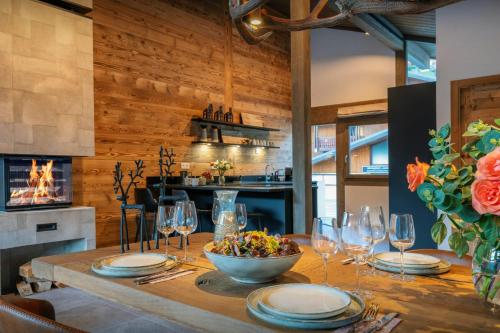 a dining room with a table with wine glasses at Chalet Amarou - OVO Network in Châtel