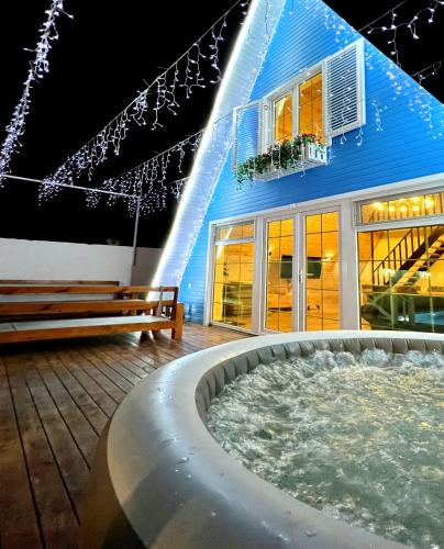 a building with a hot tub in front of it at Qafqaz Resort Melisa in Gabala