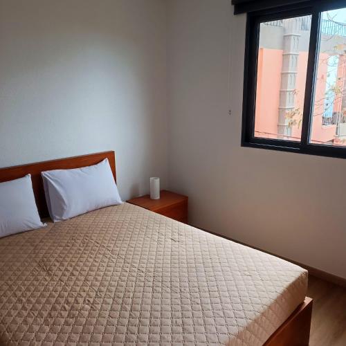 a bedroom with a bed and a window at Casa Bela Vista Studio 1 in Ribeira Brava