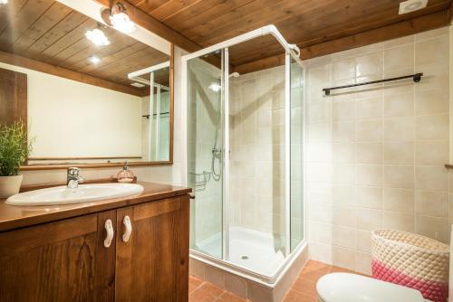 a bathroom with a glass shower and a sink at Casa Aran by Totiaran in Naut Aran