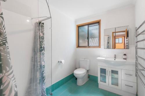 a bathroom with a toilet and a sink and a shower at Blue House Surf Shack - Pet Friendly in Lennox Head