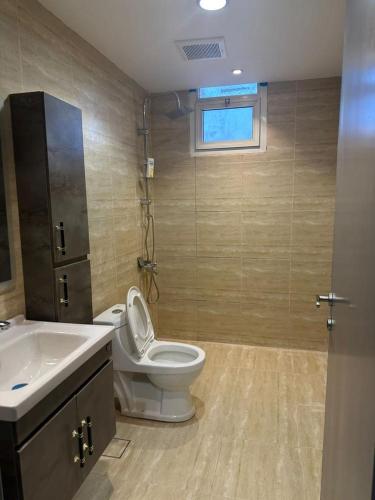 a bathroom with a toilet and a sink at وناسه مودرن in Riyadh