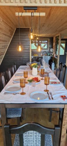 a long table with plates of food on it at Cabana Vlad Maramureș in Deseşti