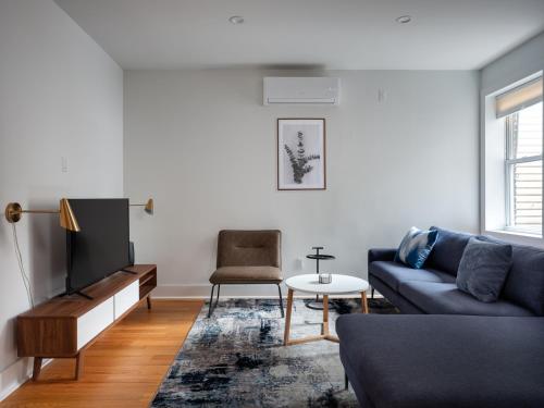 a living room with a couch and a tv at Three Bedroom Brooklynite Condo-Hotel Suite! in Brooklyn