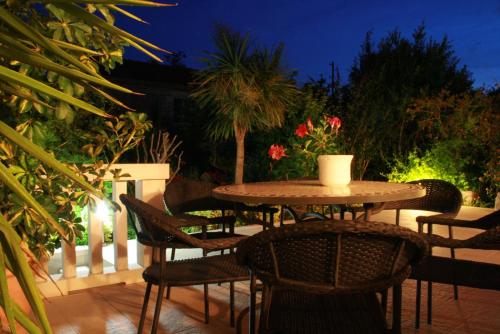 a table and chairs on a patio at night at Villa Pina Lumbarda in Lumbarda