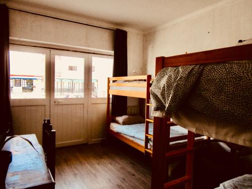 Zimmer mit 2 Etagenbetten und einem Fenster in der Unterkunft Yard in Amora