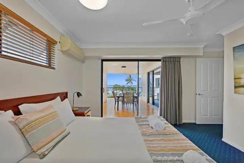 a bedroom with a large bed with a view of the ocean at Ocean Breeze 3BR Apartment in Bargara