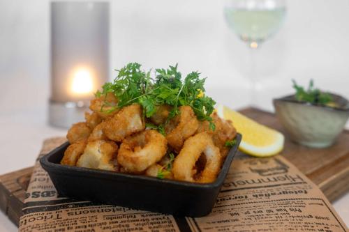 a bowl of shrimp on a table with a lemon at Park Inn by Radisson Oslo Airport Hotel West in Gardermoen